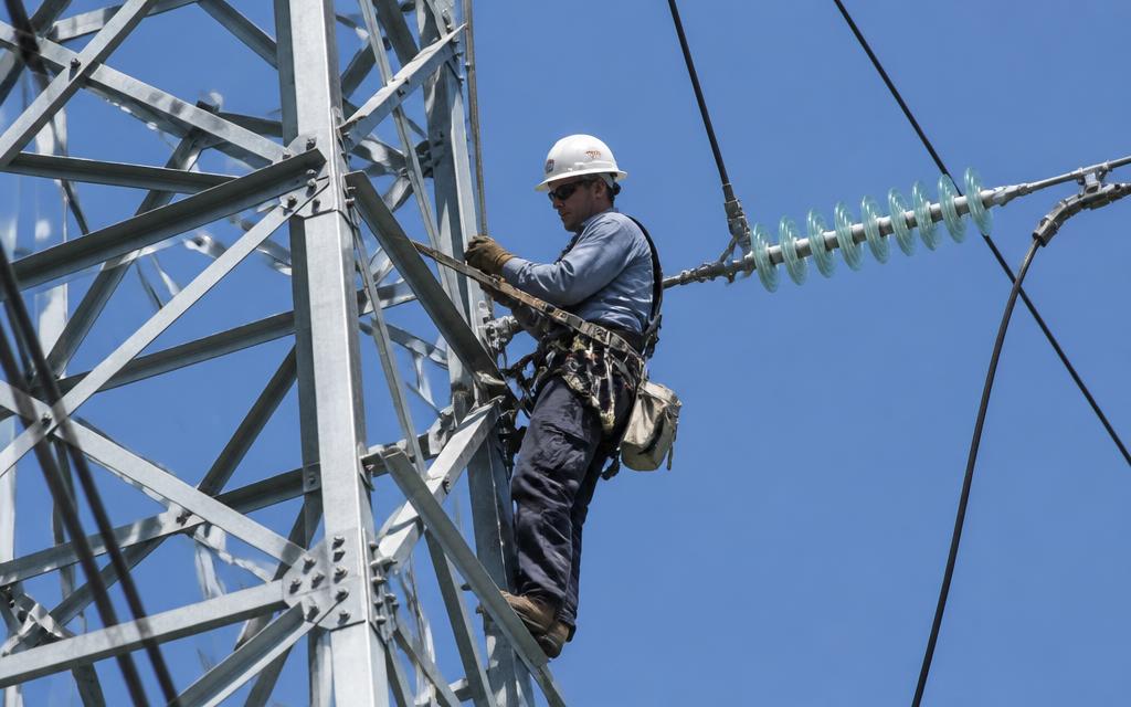 Lineman working on a transmission tower